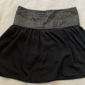 Black skirt with a zipper on the back and leather waist.